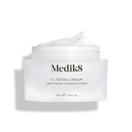 Medik8 C-Tetra Cream jar displayed open against a clean white background with soft shadows. The white, frosted-glass jar features the Medik8 logo and is labeled "C-TETRA CREAM Lipid Vitamin C Radiance Cream" in a 50mL size. A thick swirl of white cream is visible on top of the jar, highlighting its moisturising texture.