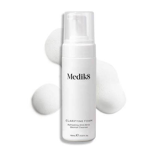 Medik8 Clarifying Foam pump bottle displayed on a clean white background with three dollops of white airy foam. Text identifies it as a Refreshing AHA/BHA Blemish Cleanser in a 150mL size.