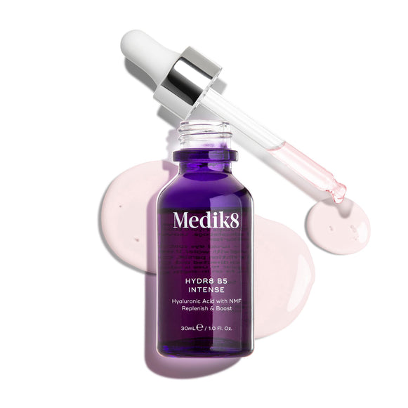 Medik8 Hydr8 B5 Intense glass dropper bottle in deep purple, shown with an open pipette resting above light pink serum droplets on a clean white background. Text highlights the formula as Hyaluronic Acid with NMF (Natural Moisturising Factors) to Replenish & Boost in a 30mL size.-6