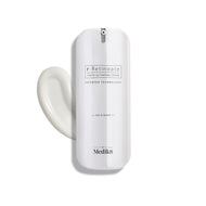 A sleek white pump bottle of r-Retinoate Day & Night stands upright, with a swirl of white cream next to it.
