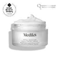 An open frosted glass jar of Medik8 Total Moisture Daily Facial Cream with a peak of white cream on top, set against a clean white background. Badges in the top corners indicate it is a "Daisy Beauty Awards Vinnare 2025" (Winner) and "Dermatologist Recommended."