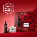 A large, hero image displaying two Medik8 skincare products – a dark dropper bottle and a white jar – on a deep red, rippled fabric background. The text 'Medik8' is visible at the top and on the product labels. Below the products, 'RADIANCE WRAPPED' is displayed, with 'BRIGHTENING & DAILY MOISTURE' and 'TOTAL MOISTURE DAILY FACIAL CREAM' below it.