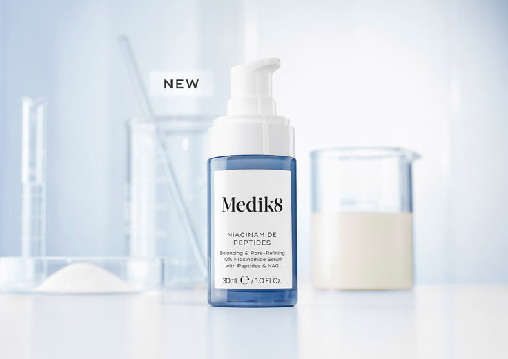 Niacinamide Peptides bottle on a light blue background with NEW badge 