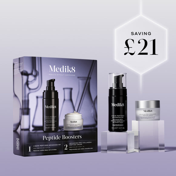 The Medik8 Peptide Boosters kit box and products displayed on clear blocks against a lilac background. A glowing hexagonal graphic highlights a saving of "£21."-1